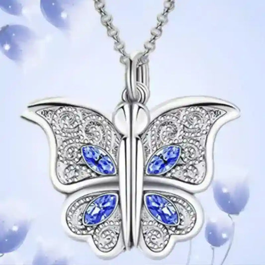 Butterfly-shaped pendant with blue gemstones on a light blue background