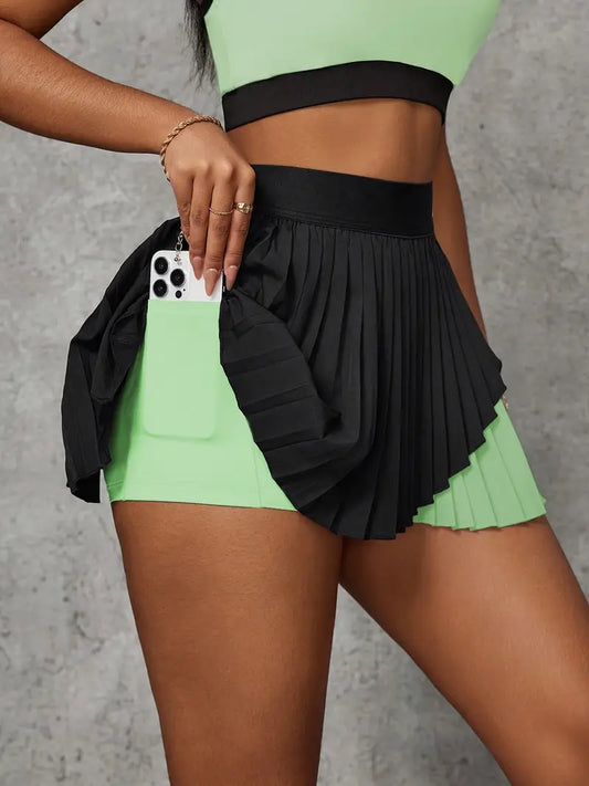 Person wearing a green sports bra and black shorts with a gray background